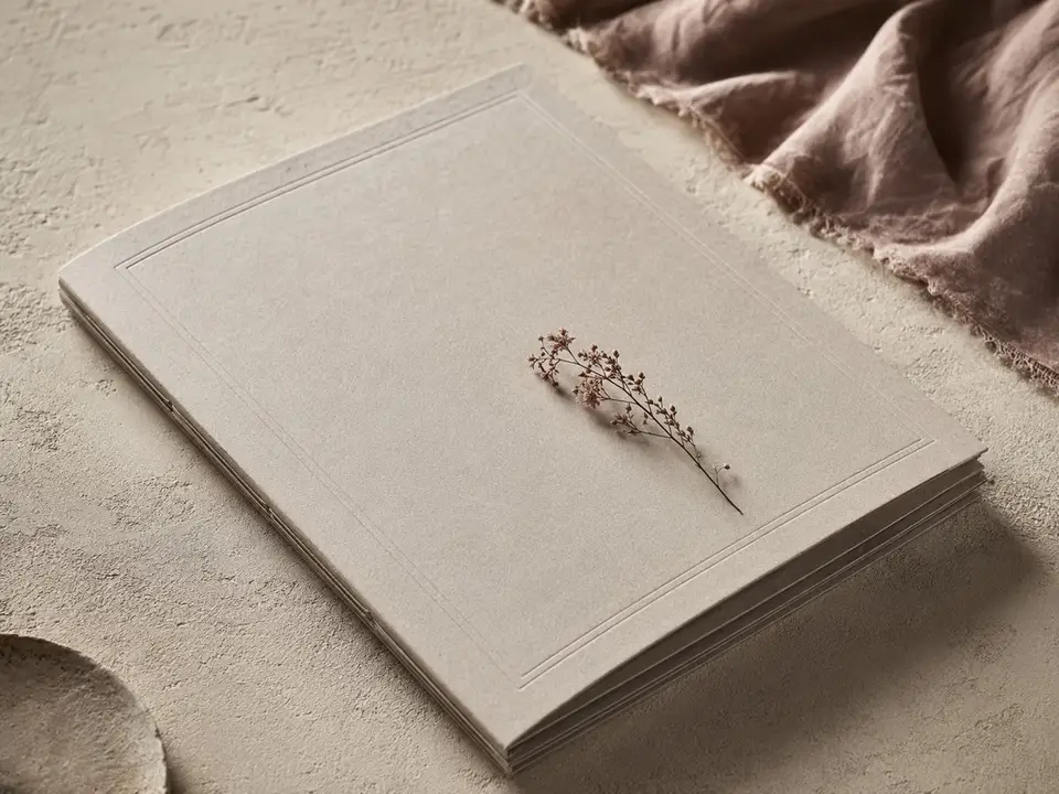 Restrained wedding invitation zine with subtle embossed details